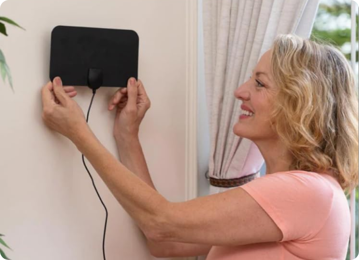 Woman mounting NovaWave on a wall